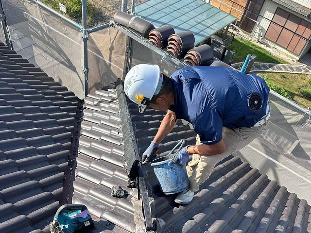 屋根棟瓦取り直し工事で棟部に南蛮漆喰を盛り付けている状況