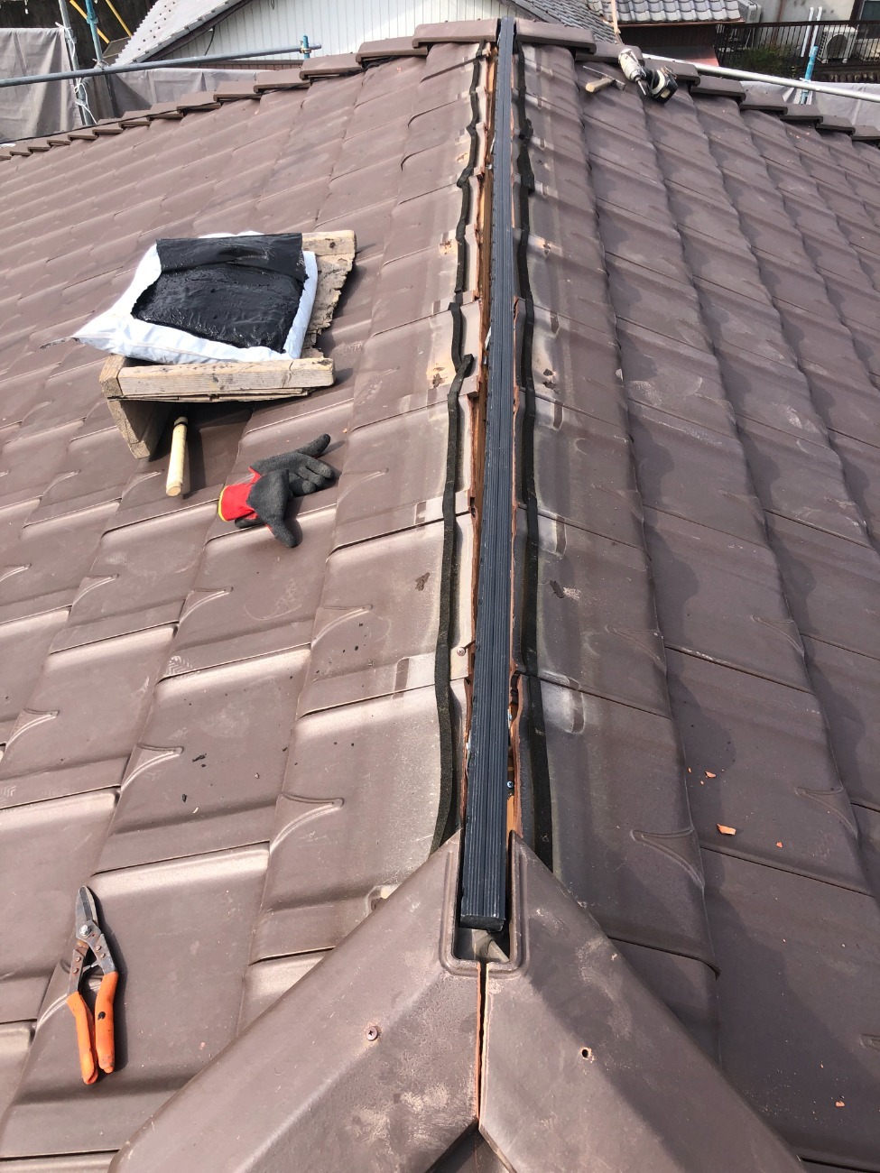 屋根の頂上にある棟部の修復工事で樹脂垂木を設置